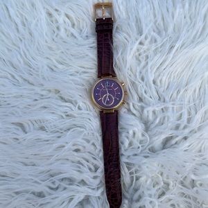 Michael Kors maroon leather watch with gold metal accents.
